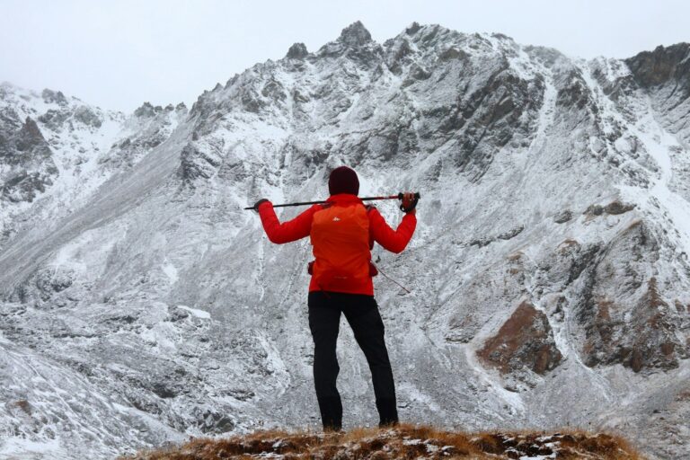 a man standing on top of a snow covered mountain